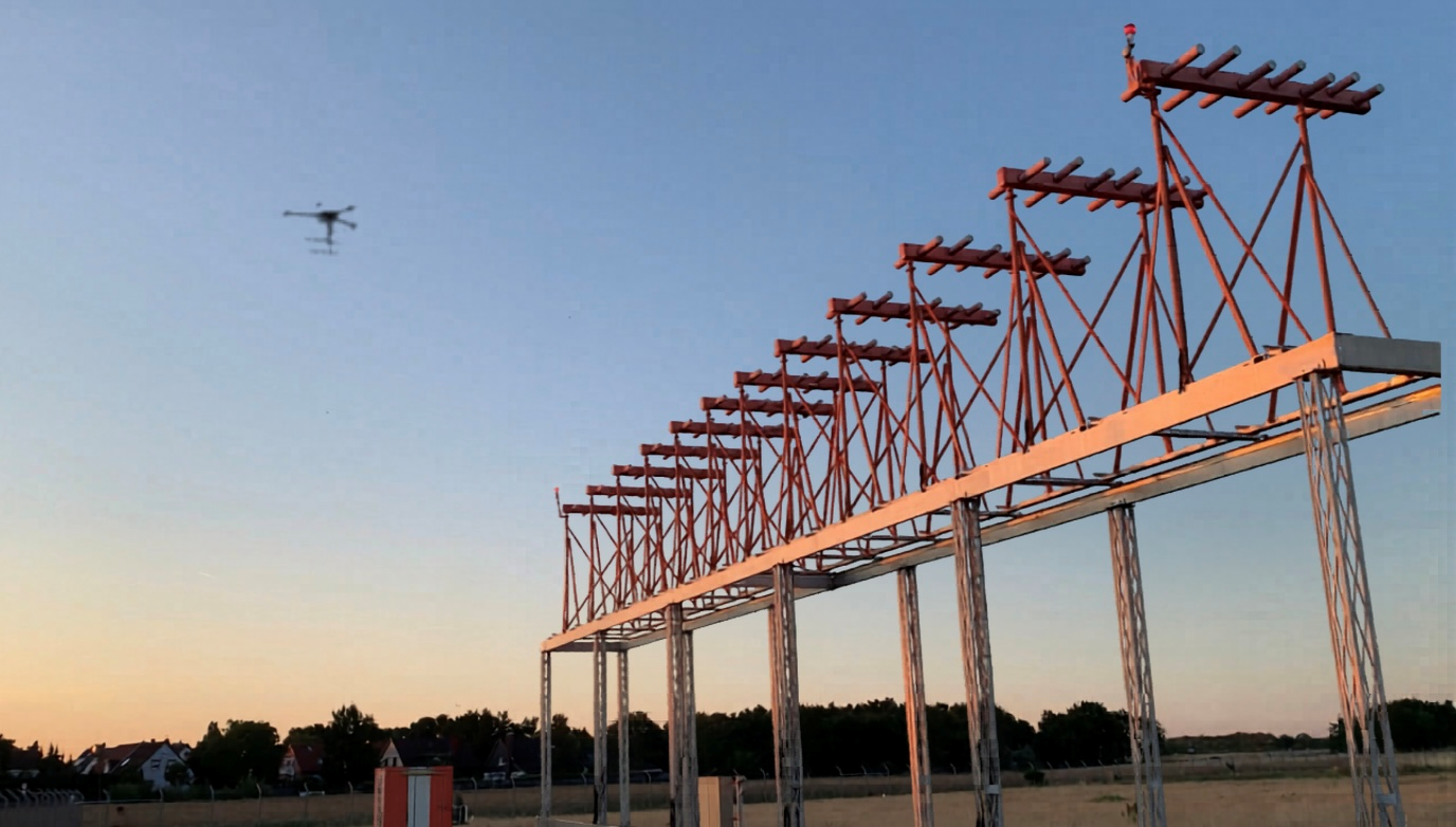 drone flying behind a instrument landing system. The ILS-localizer is an arrangement of several antennas with a spacing of about 2.5 meters